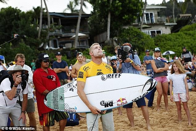 The 42-year-old is pictured about to paddle out in Hawaii just hours after learning his brother Peter had died from an enlarged heart in December 2015.