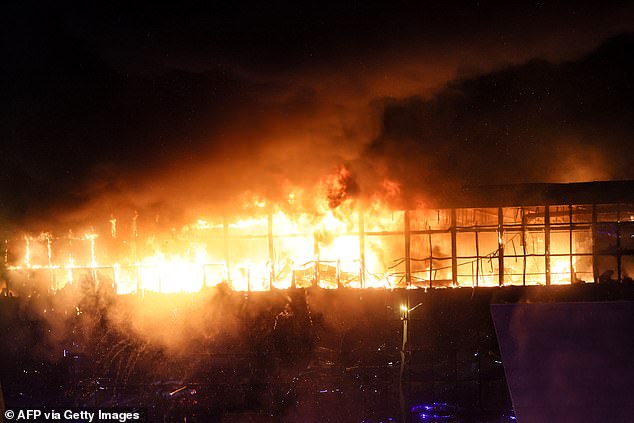 A view shows the Crocus City Hall concert hall on fire following the shooting in Krasnogorsk, outside Moscow, on March 22, 2024.