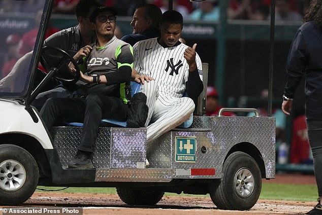 He sat upright and gave a thumbs up to the fans as he was wheeled off the field on a cart.