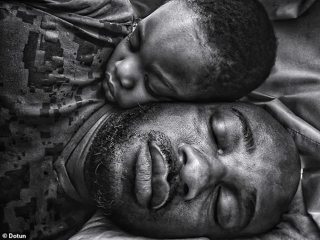 Titled Two Heads, One Heart, the stunning photo was taken on a Samsung Galaxy Note 20 Ultra in Hellesdon, Norwich, by father Dotun, who captured the image after his son fell asleep next to him.