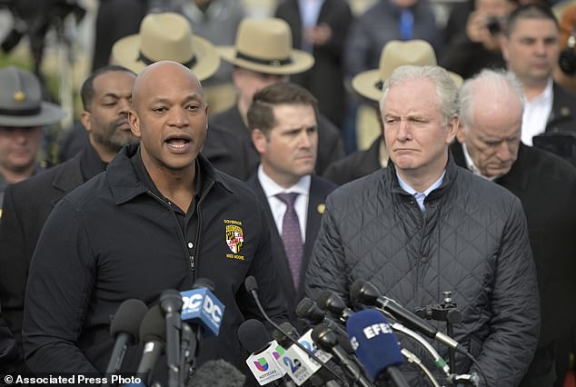 Maryland Governor Wes Moore (left) speaks during a press conference as Senator Chris Van Hollen looks on near the scene.