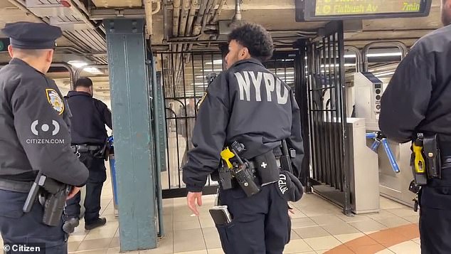 A large number of officers were present at the scene along with several New Yorkers caught standing on the platform as word spread about a man beneath the tracks.