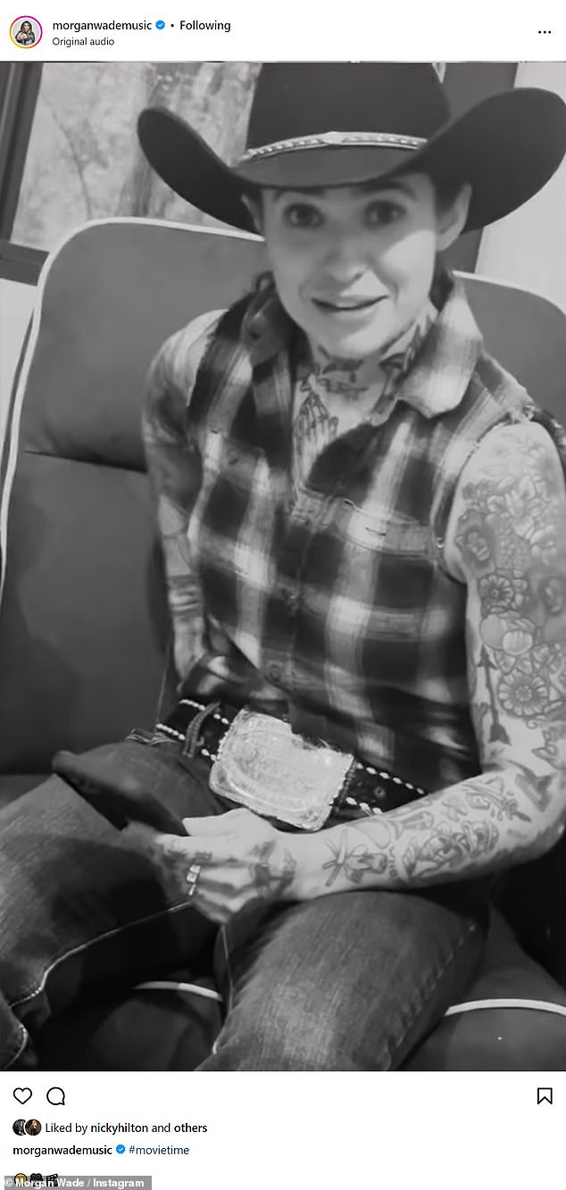 Morgan was wearing a sleeveless plaid shirt, jeans and a black cowboy hat and his heavily tattooed arms were on display.
