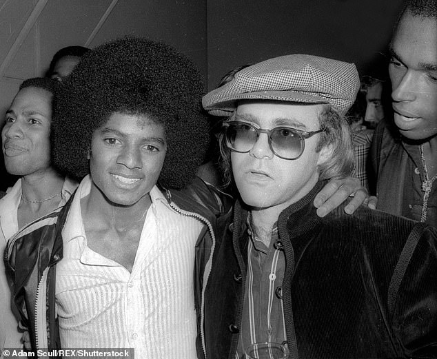 The 27-year-old star appeared to film a scene filmed in the 1970s, based on his afro wig and vintage cars parked on the street; Pictured with Elton John in 1978 in New York.