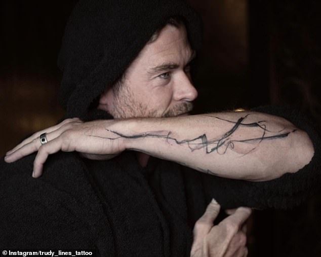 Chris proudly showed off his newly tattooed arm, showing off a striking display of abstract lines on his left forearm.