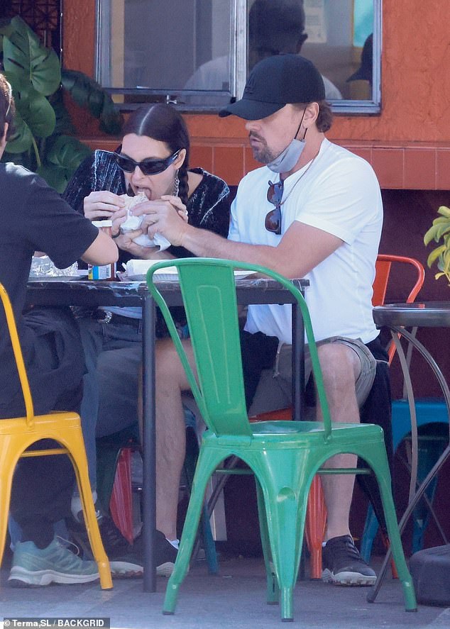 The duo sweetly shared a burrito, with Leo feeding his lady love while she took a bite.