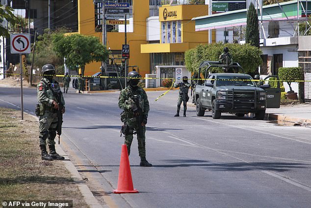 The Mexican army guards a street in Culiacán, Sinaloa, on Monday, a day after a member of the National Guard was killed in a shootout during an operation that allowed 16 people who had been kidnapped to be rescued.