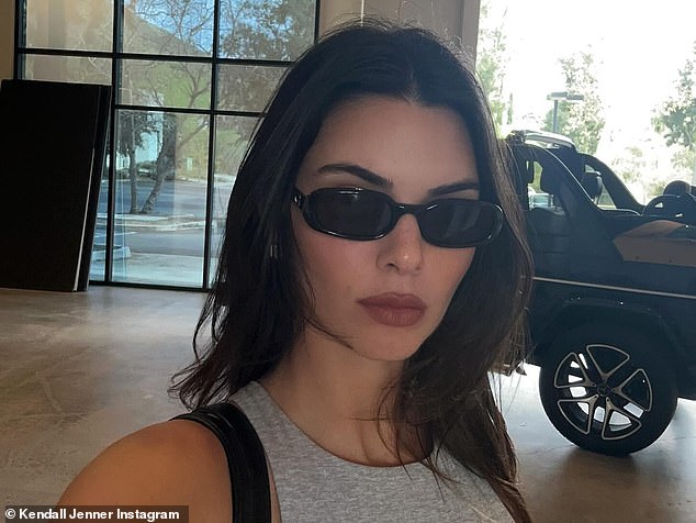 Jenner's dark brown hair was styled in loose layers around her shoulders.  The cover model wore natural-looking makeup with a deep red lip and accessorized with dark sunglasses.