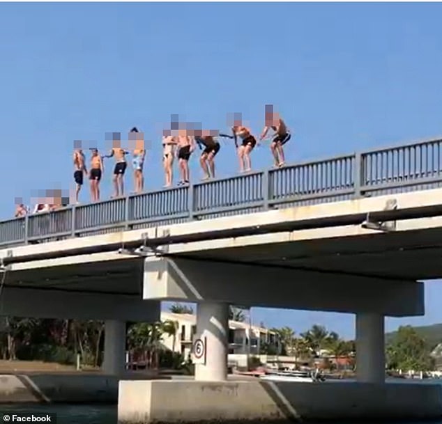 The tragic death comes after several warnings from police against jumping from the Noosa Sound Bridge (file image of people jumping from the bridge)