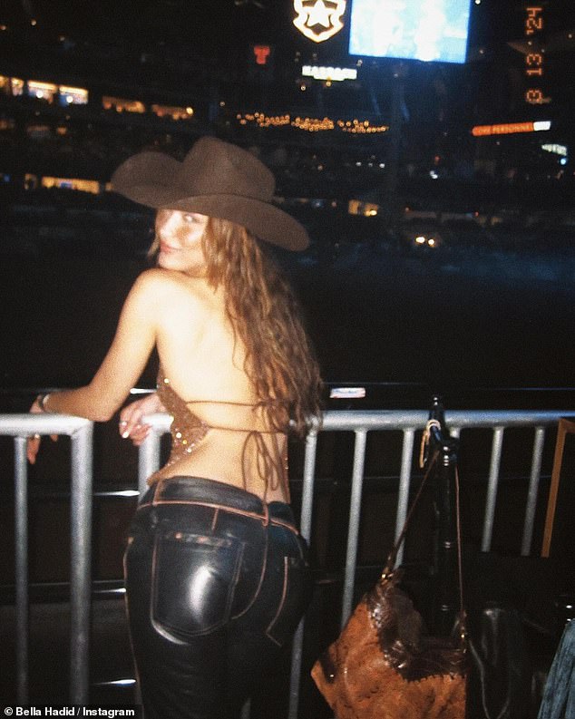 Bella was every inch the sexy cowgirl in her backless strappy top.