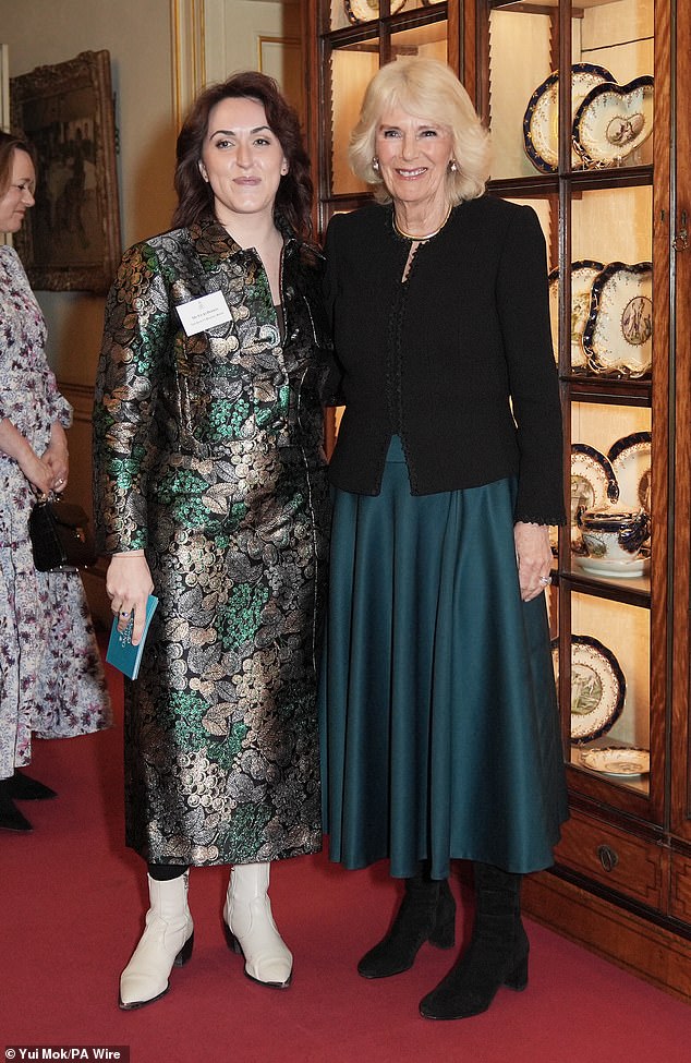 Queen Camilla tonight backed new research which says five minutes of reading a day is as valuable to health and wellbeing as walking 10,000 steps and eating five portions of fruit and vegetables. Pictured with Vicki Perrin