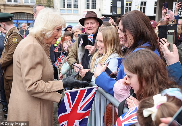 Queen Camilla smiles as she meets well-wishers during her visit to the farmers market on Wednesday.