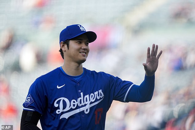 The Japanese two-way star greets the fans, who stood to welcome him back to Angel Stadium