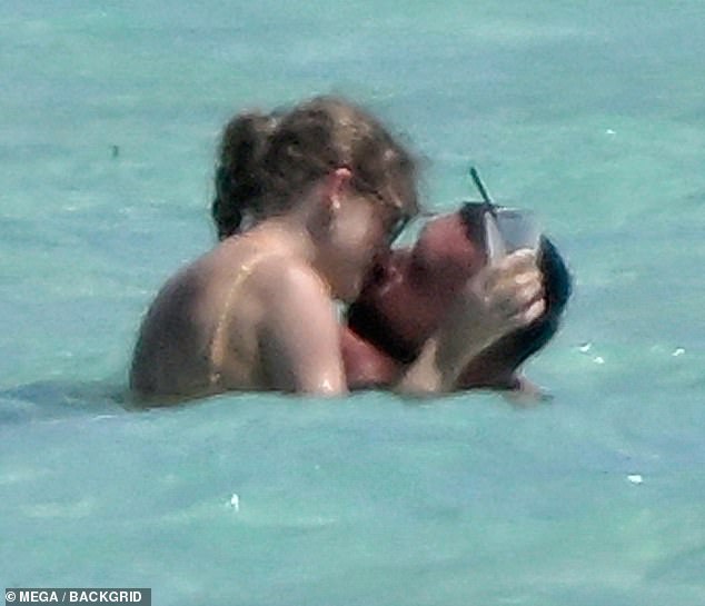Taylor and Travis Kelce were spotted sharing a passionate kiss while frolicking on the beach in the Bahamas last week.