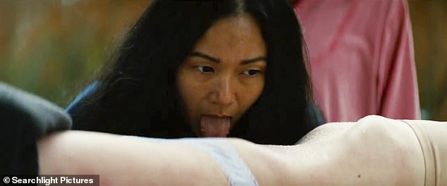 Hong Chau drags his tongue across a half-naked woman's stomach in another shot