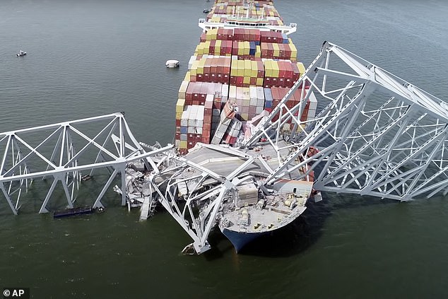 The freighter Dali becomes trapped beneath part of the Francis Scott Key Bridge structure after the ship collided with the bridge.
