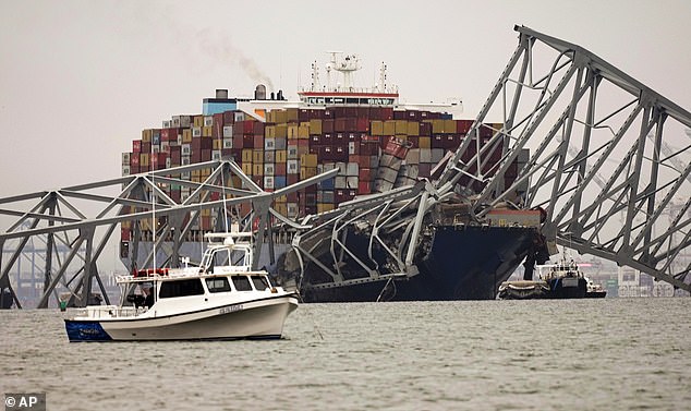 A freighter crashed into a support structure of the Francis Scott Key Bridge just before 1:30 a.m. Tuesday morning, causing the 1.6-mile-long bridge to collapse into the Patapsco River.  In the photo: The ship remains trapped under the ruins of the bridge on Wednesday, March 27.