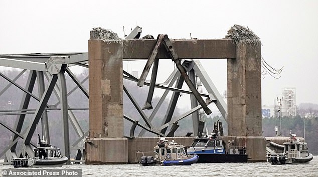 Police dive boats work around part of the Francis Scott Key Bridge structure after the boat collided with the bridge on Wednesday.