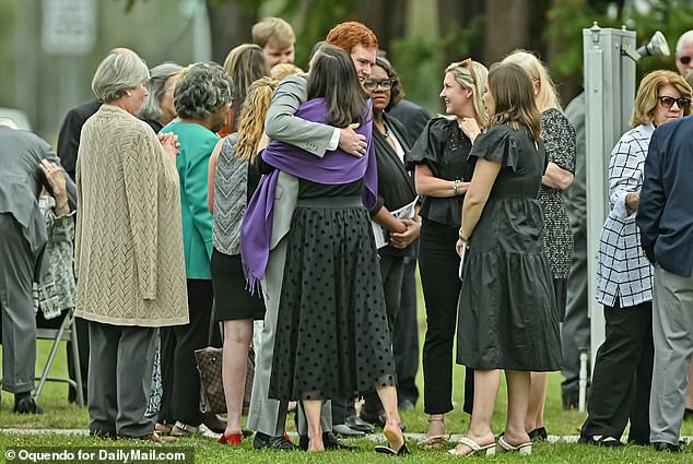 He was seen sharing an emotional hug with a family member as family members gathered outside the church.