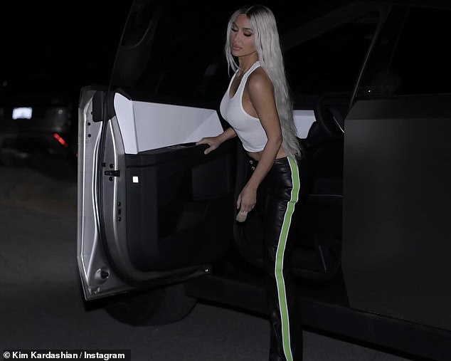 She contrasted the garment with a set of tight black leather pants with neon green stripes along the sides of the legs, along with pointed-toe boots.