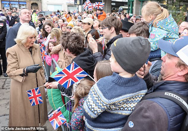 Queen Camilla smiles in Shrewsbury as she meets the public during her visit to the farmers market.