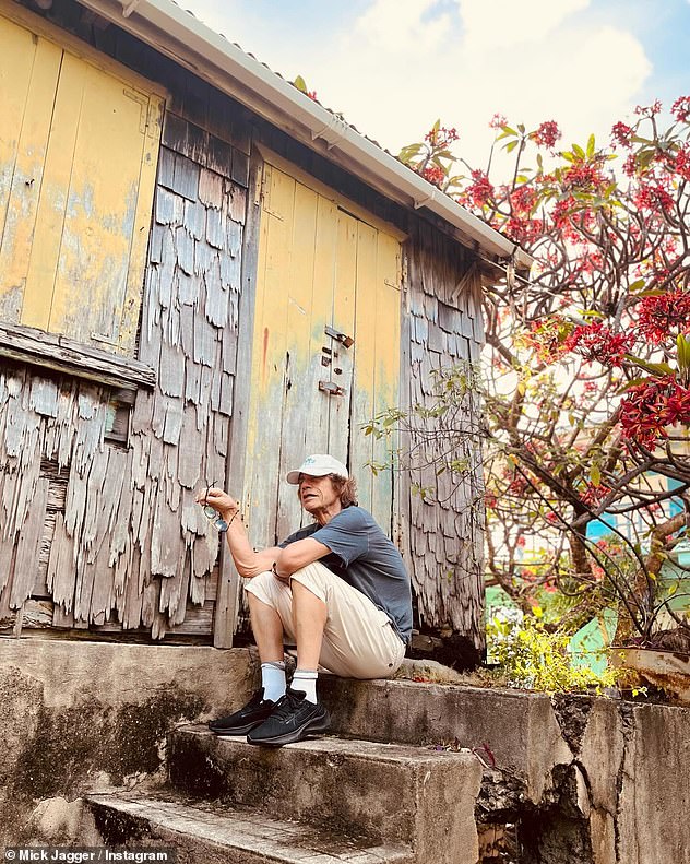 Rocker Mick cut a casual figure in a gray t-shirt and white shorts as he explored 'Cloud Island' in Arawak.