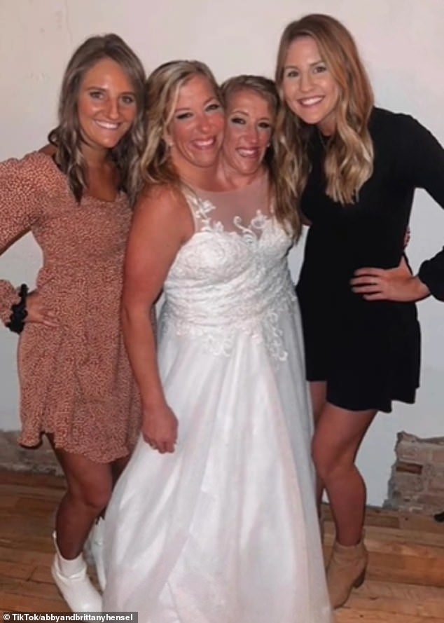 Here's Abby stunning in a floor-length white dress on her wedding day.