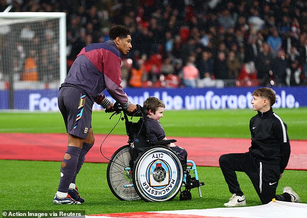 Bellingham came out to line up for the national anthems alongside the mascot, who was in a Manchester City-themed wheelchair.