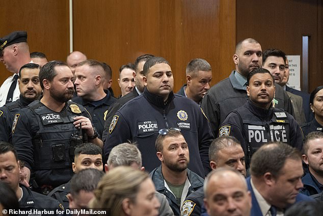 Hundreds of NYPD officers descended on the Queens courthouse Wednesday to witness the arraignment.