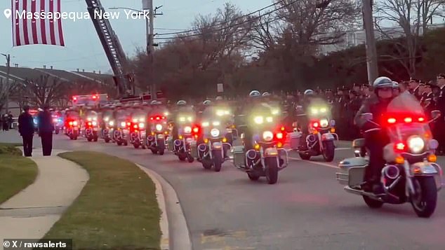 Thousands of law enforcement officers watched as Diller's body arrived at the upstate New York funeral home where his service will be held Thursday.