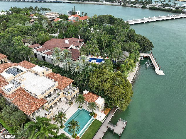 Law enforcement at Diddy's Star Island mansion in Miami Beach during a raid for alleged sex trafficking.  Federal agents are seen on the extensive coastal platform