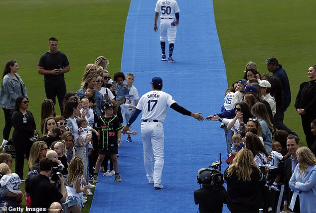 He greeted fans on the blue carpet and exited to a standing ovation from the crowd.