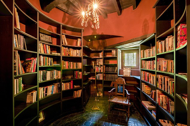 The decoration of Château Bourgogne is “farmhouse chic” with exposed beams and stone floors.  In the photo, the library