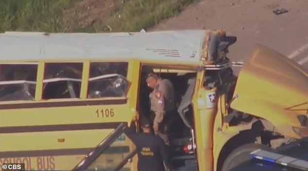 Officers can be seen investigating the wreckage of the school bus following last week's incident.