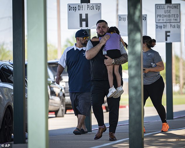 Families reunite with their children at Tom Green Elementary School in Buda, Texas, after the school's preschool students were involved in a bus accident.