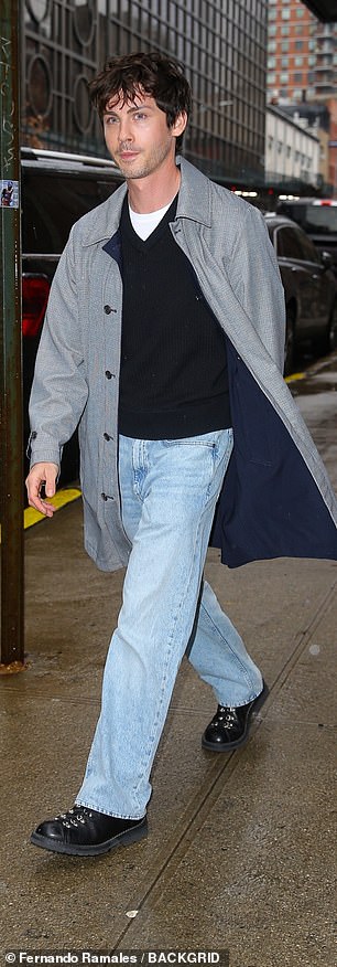 Meanwhile, Logan wore a black V-neck sweater over a white T-shirt with light wash jeans and a large coat.