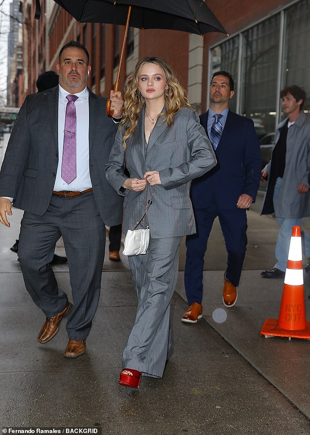 The InBetween star rocked an oversized gray suit with a pair of red platform heels.