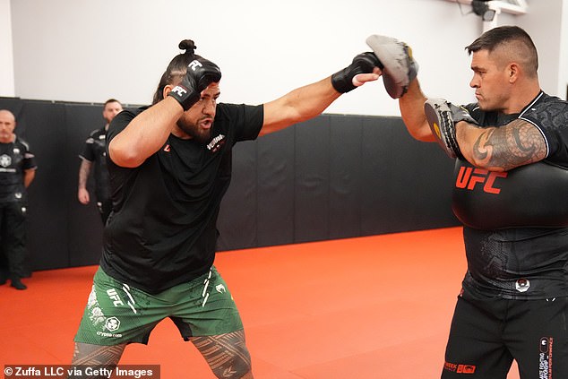 Tuivasa (pictured left in training) has knocked out 13 opponents in spectacular fashion on his way to a 14-7 MMA record.