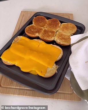 He doesn't separate the rolls but cuts them in half, covers half with slices of cheese and puts them in the oven to melt.