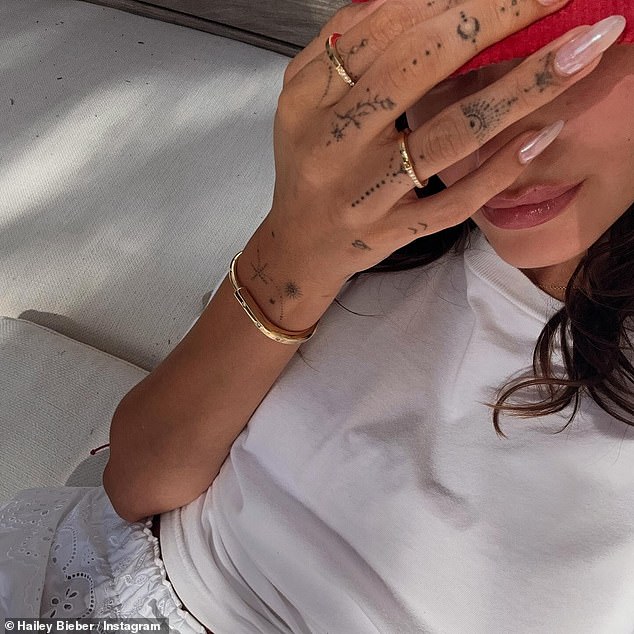 Hailey held up her phone to take a variety of snaps while showing off a gold bracelet on her right wrist and some rings on her hand.