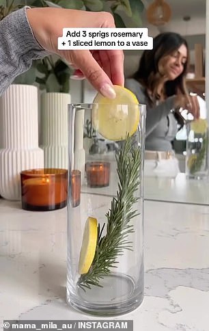 Chantel begins by filling a clear glass vase with water and adding three sprigs of rosemary and a whole sliced ​​lemon.