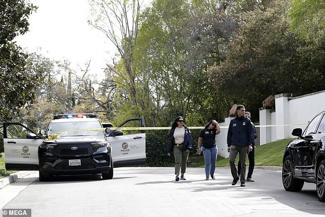 A man believed to be Diddy's head of security, Faheem Muhammad, is seen arriving at Diddy's Beverly Hills mansion following the raid on the property.