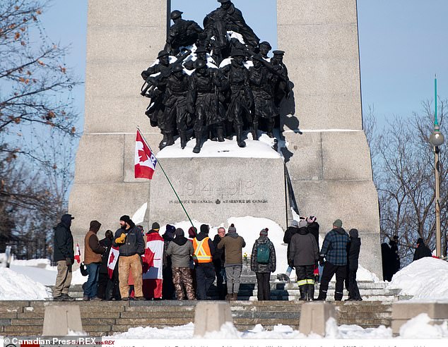 People surround the Tomb of the Unknown Soldier at the National War Memorial during a demonstration against COVID-19 restrictions.