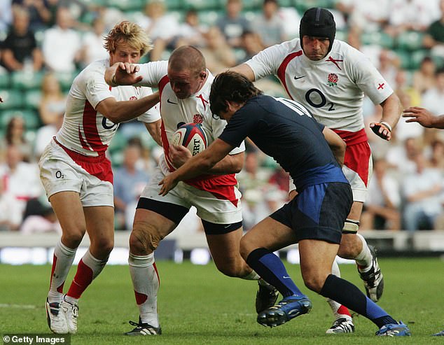 Phil Vickery advances as David Skrela tackles him at a rugby match between England and France at Twickenham in August 2007.
