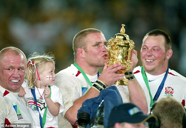 Vickery (centre) kisses the trophy after England's victory against Australia in the 2011 Rugby World Cup final
