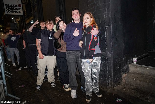 LEEDS: A group of friends wait patiently for their next pints next to a dark, damp wall