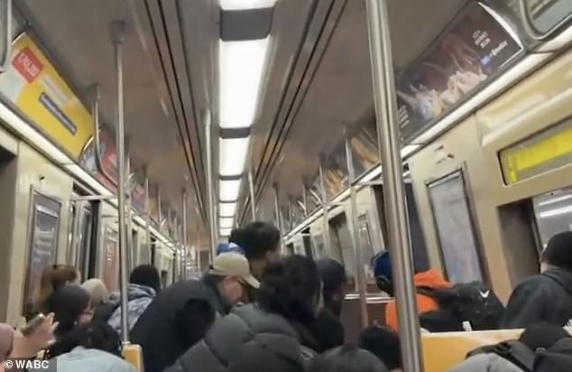 In separate images after the shooting, a train car full of people is seen cowering in fear and begging the subway to move away from the crime.