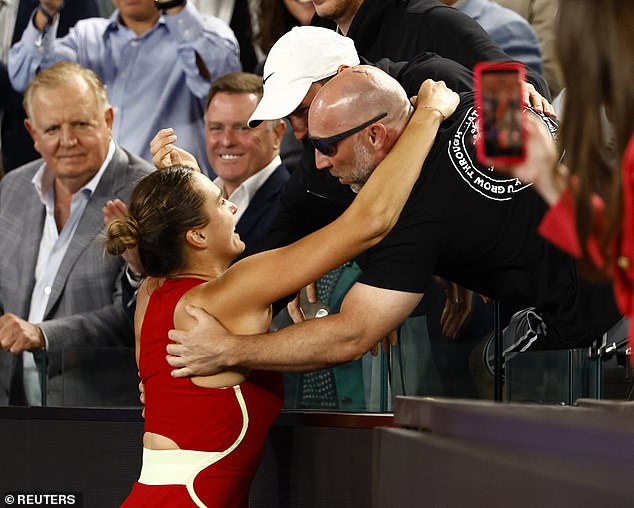Koltsov (pictured in the white cap) was in Sabalenka's box to watch her win the Australian Open in January.