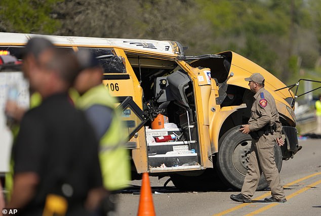 A Texas Department of Public Safety trooper inspects the scene of the fatal school bus crash