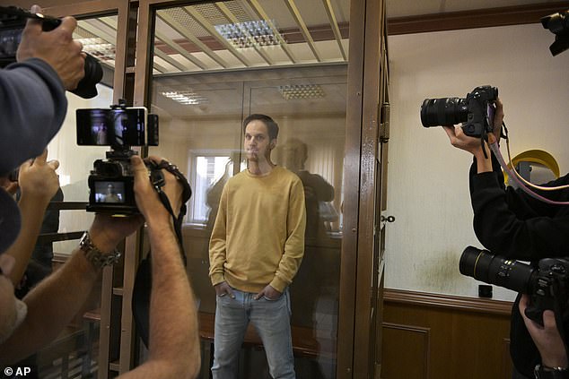 The journalist's appearances before a Russian court always provoke a multitude of cameras, as he is photographed standing defiantly at an appearance on September 19, 2023.